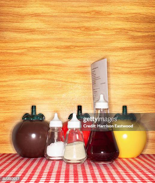 condiments and a menu on a cafe table - harrison wood stock pictures, royalty-free photos & images