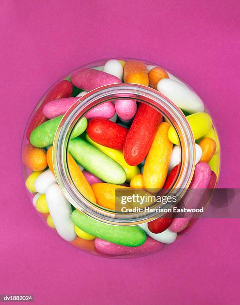 jar of multi-coloured jelly beans - candy jar stock pictures, royalty-free photos & images