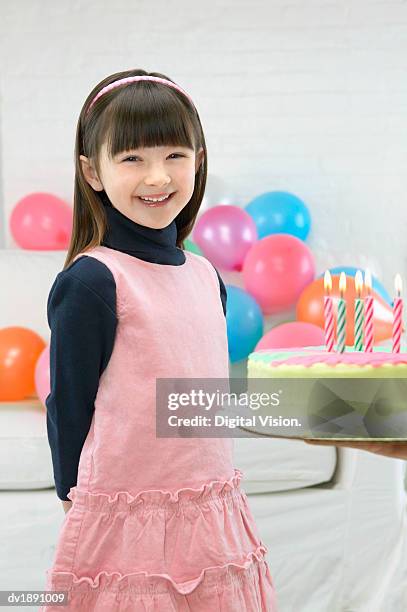 smiling girl standing next to her birthday cake - digital devices beside each other bildbanksfoton och bilder