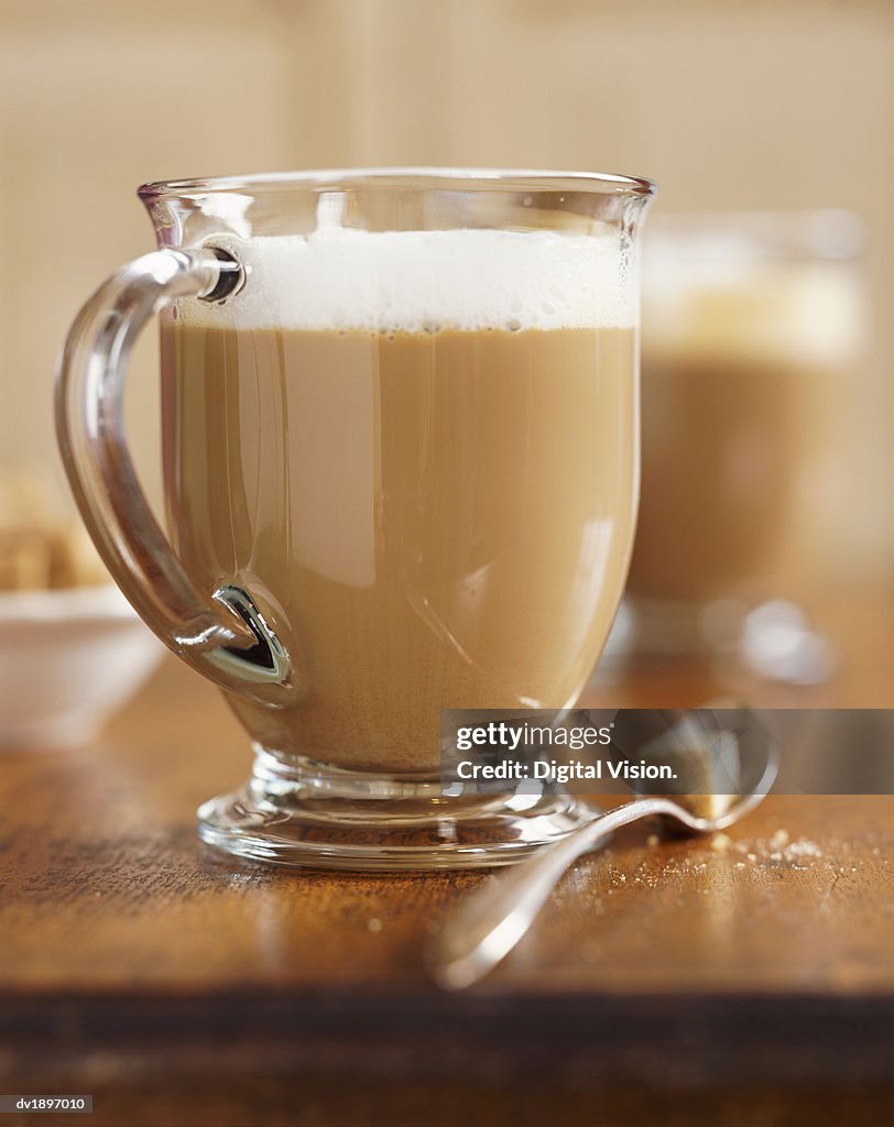 Cup of Cappuccino and Spoon With Sugar Cube, Still Life