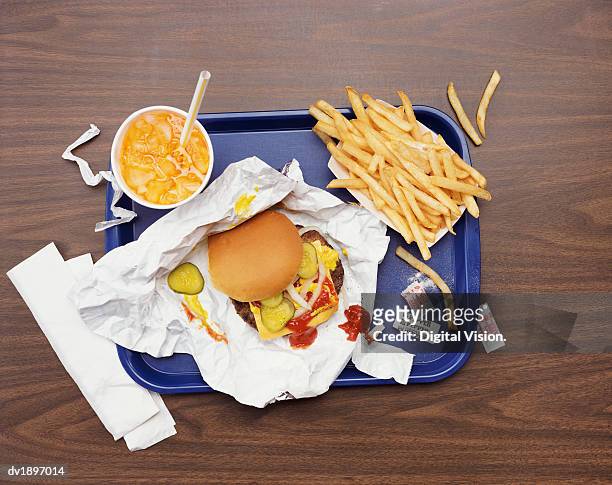 elevated view of a tray with fries, a hamburger and lemonade - unhealthy eating ストックフォトと画像