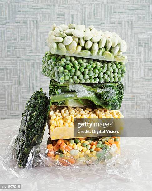 pile of frozen vegetables - frozen man stock-fotos und bilder