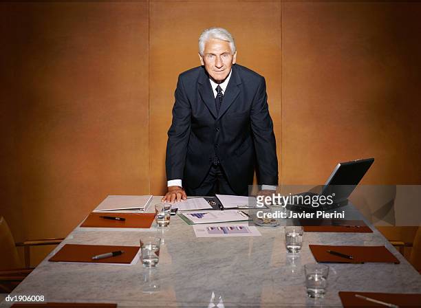 businessman standing at the end of a marble table, in a conference room - marble - fotografias e filmes do acervo