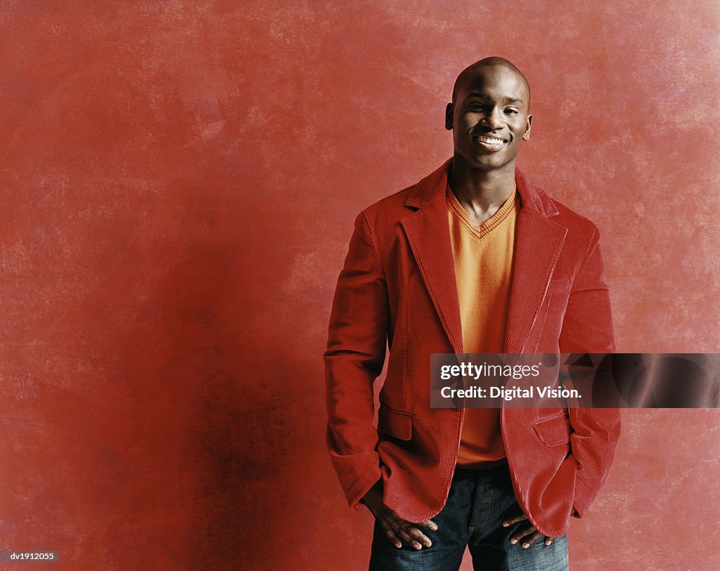 Studio Portrait of a Smiling Young Man in a Red Jacket