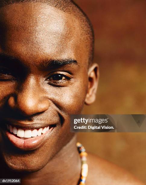 cropped close-up of a smiling young man with a shaved head - shaved head ストックフォトと画像