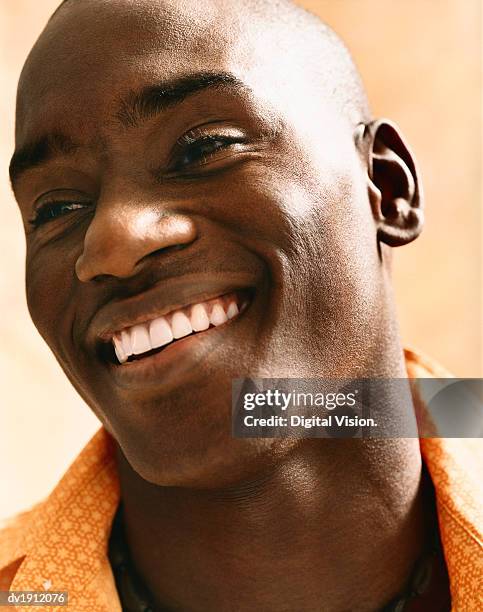 headshot of a young man with a shaved head, laughing - shaved head ストックフォトと画像