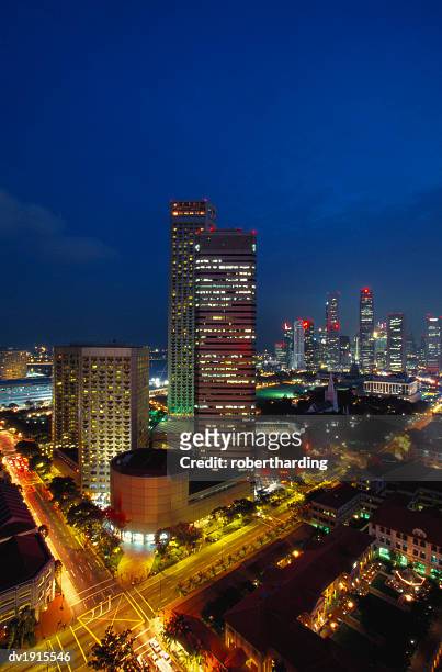 raffles hotel at night and skyline, singapore, asia - singapore stock-fotos und bilder