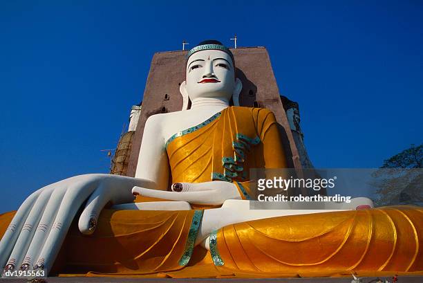 large statue of the buddha at kyaik pun paya, bago, myanmar - bago stock pictures, royalty-free photos & images