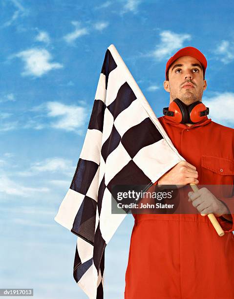 sports official holding a checkered flag - sports official stock pictures, royalty-free photos & images