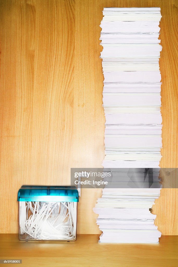 Paper Shredder and Stack of Paperwork