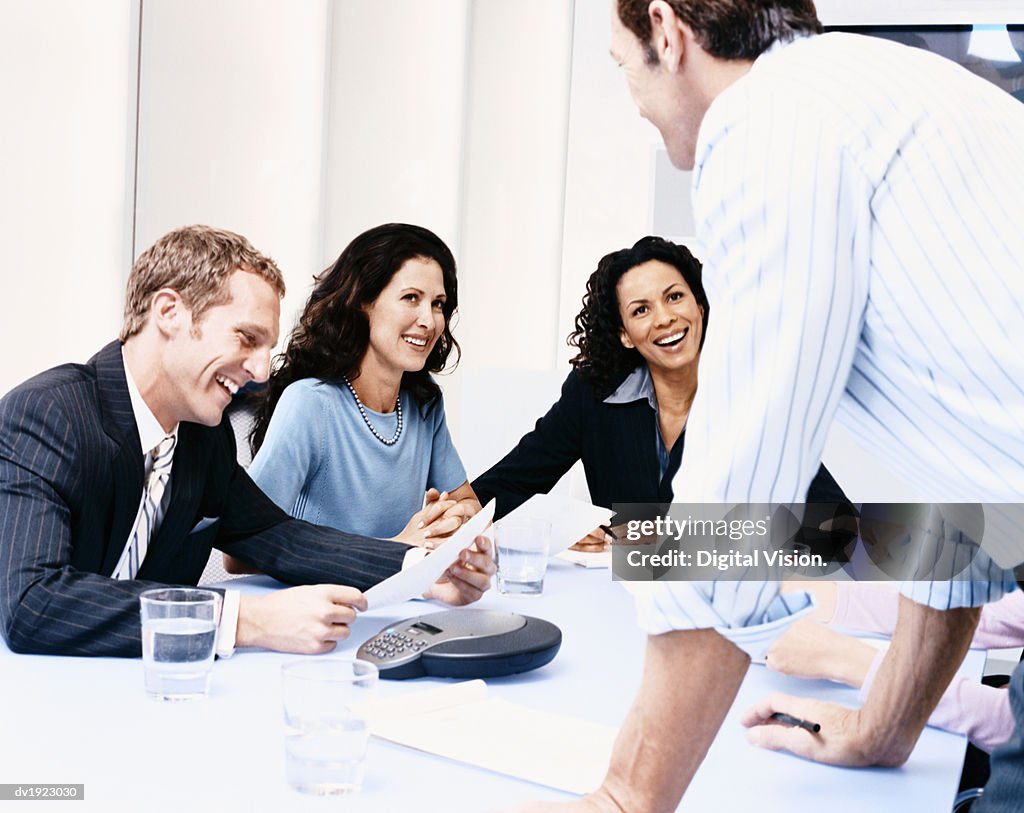 Group of Businesspeople at a Meeting, Laughing and Talking