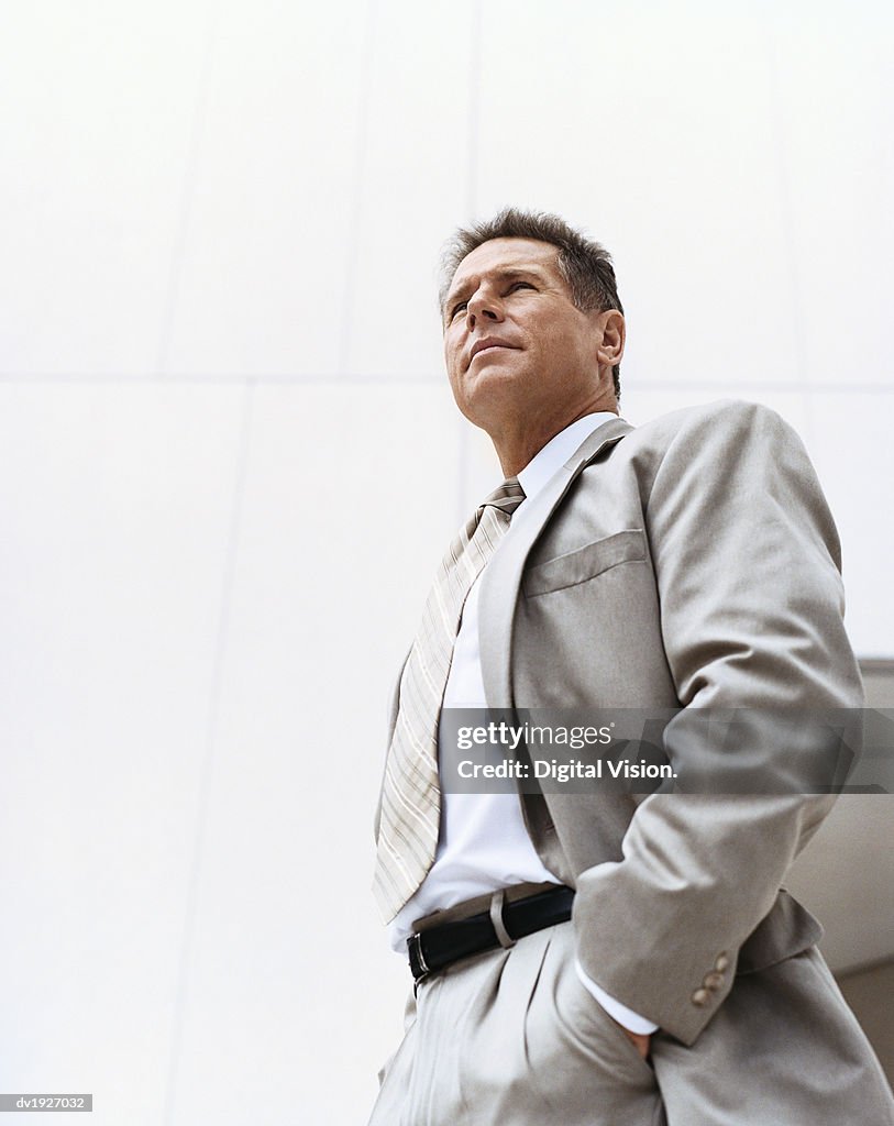 Low Angle View of a Mature Businessman Standing With His Hands in His Pockets