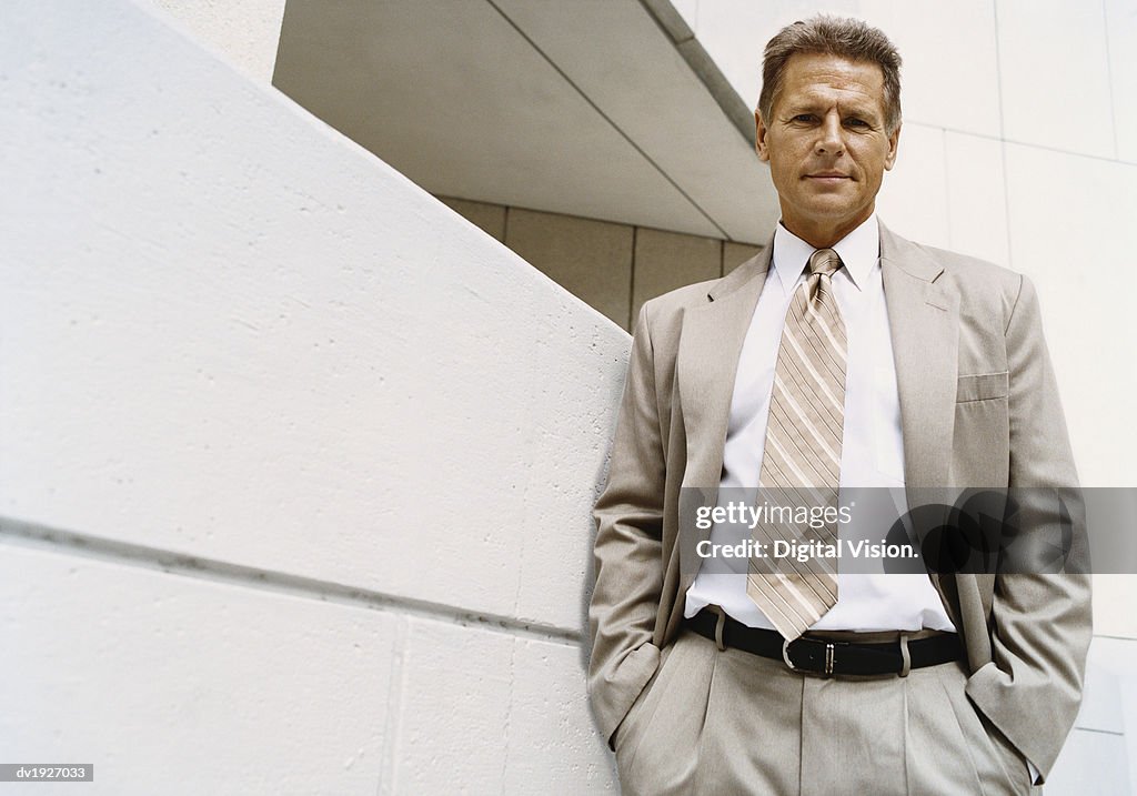 Confident Businessman Standing in Front of a Building Exterior