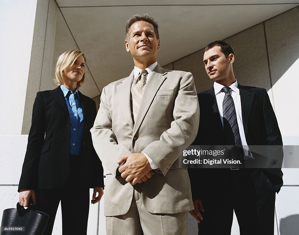 Mature CEO Businessman Outdoors Standing Confident With Male and Female Colleagues