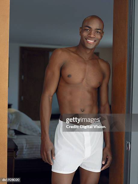 man in his boxer shorts standing in bedroom door - boxer imagens e fotografias de stock