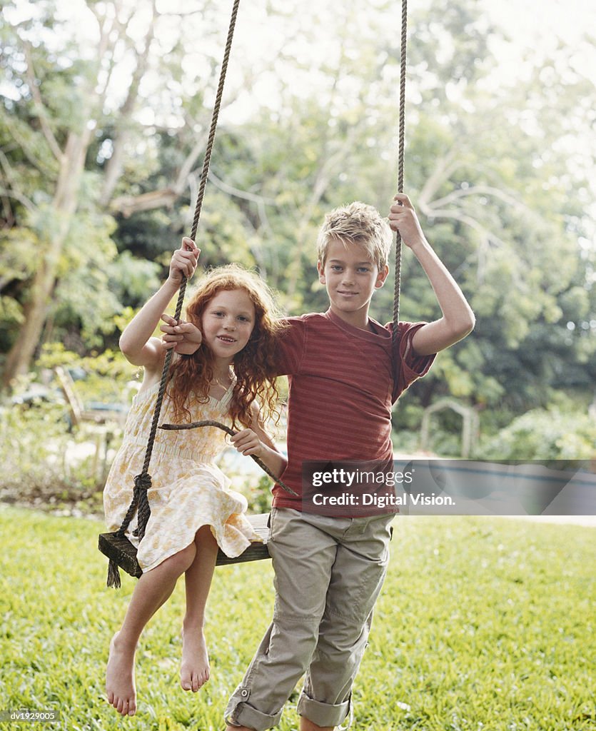 Portrait of Brother and Sister By a Swing