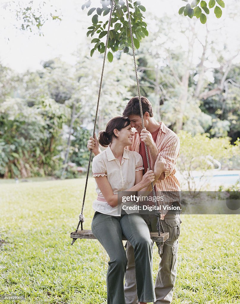 Smiling Couple By a Swing