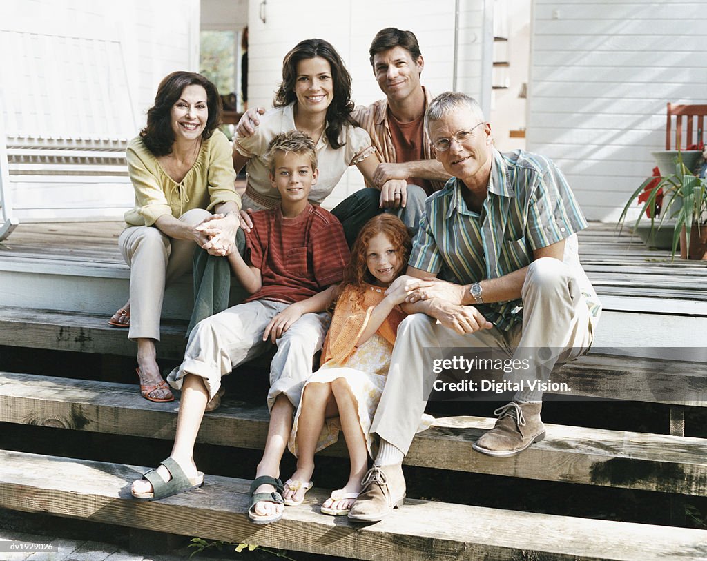 Portrait of a Family Sitting on the Patio Steps of Their Home