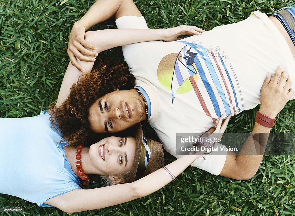 Cool Twentysomething Couple Lying on Grass