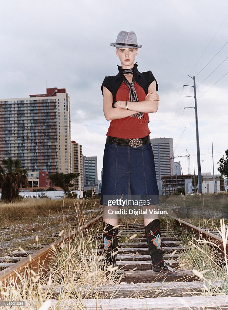 Portrait of a Woman With Attitude in Individual Clothing Standing on an Abandoned Rail Track
