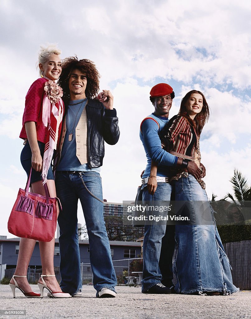 Two Young Couples in Casual, Individual Clothing, Standing in an Urban Setting