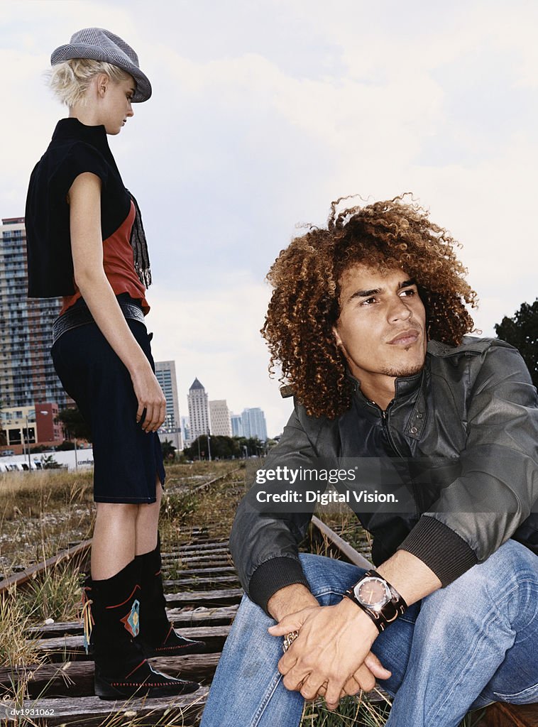 Funky Twentysomething Man and Woman on an Urban Railway Track