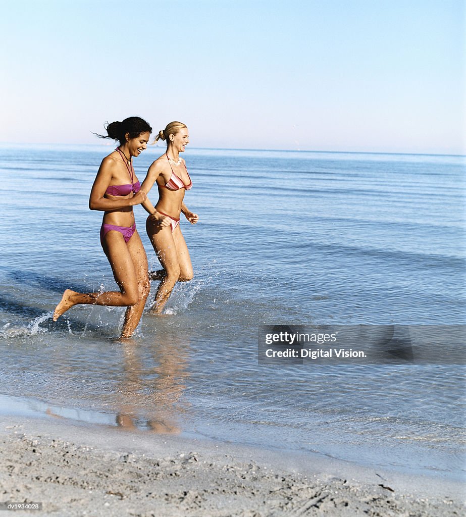 Two Young Women Running in the Sea