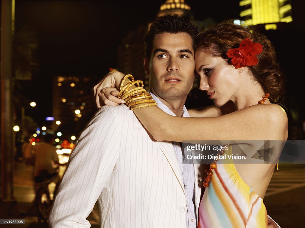 Couple Standing Outdoors, Woman With her Arms Around Him