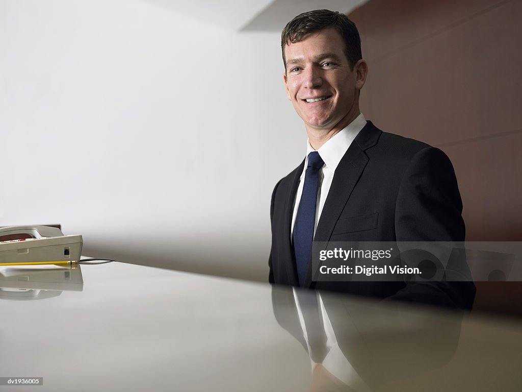 Portrait of a Businessman Waiting at a Reception Desk