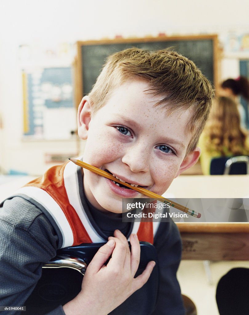 Portrait of a Primary School Boy Chewing a Pencil