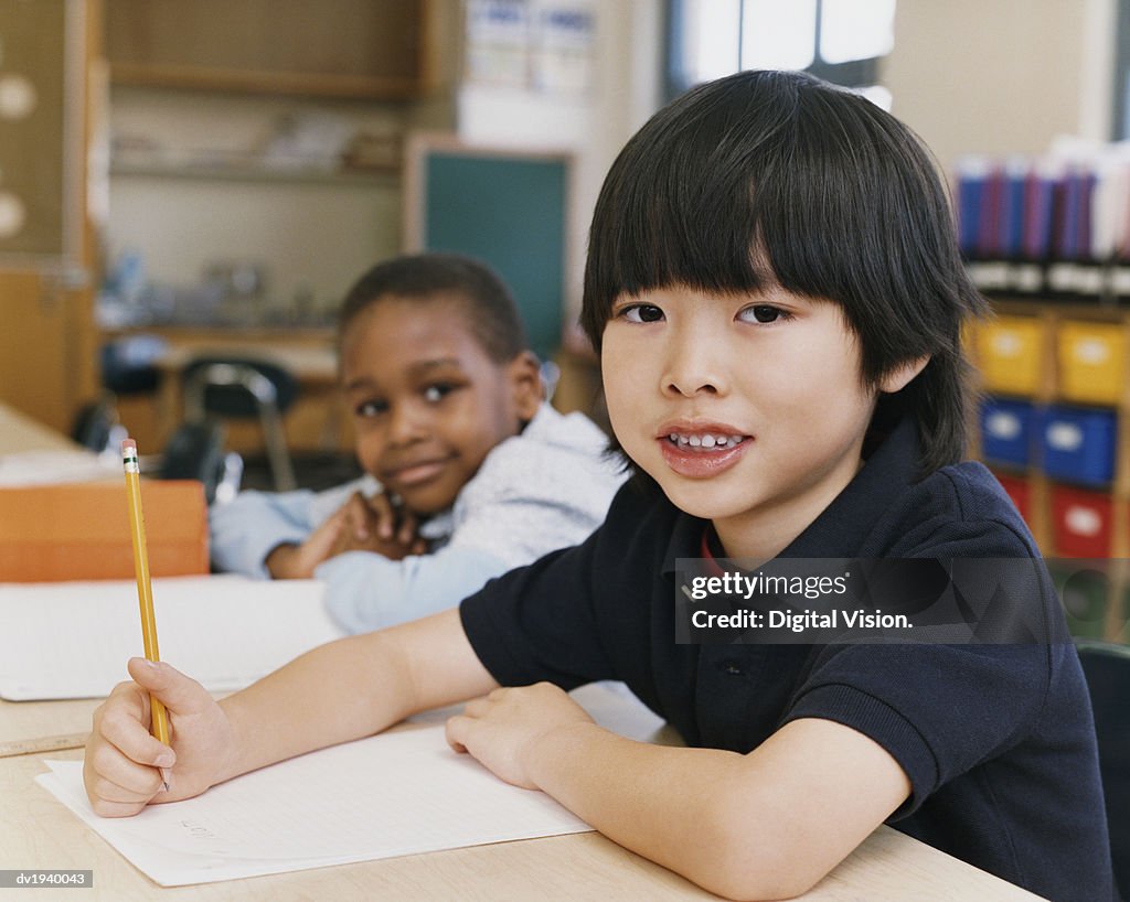 Portrait of Two Young Schoolboys Sitting at a Desk