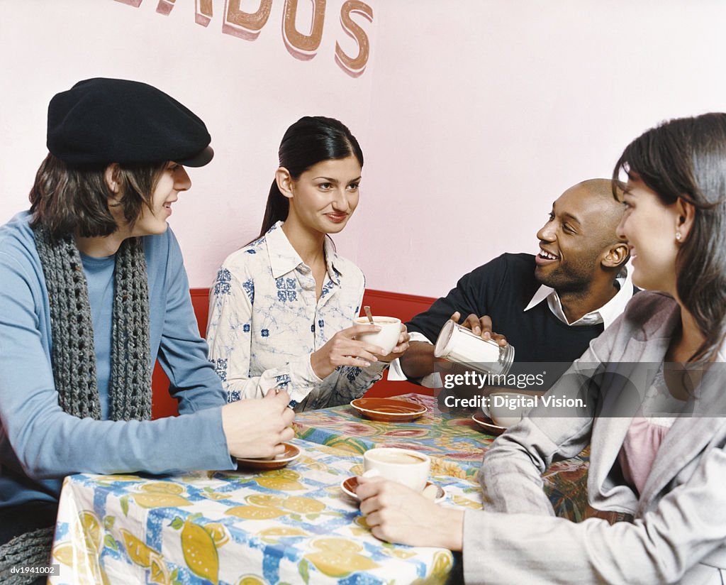 Young People Sitting at a table in a Cafe