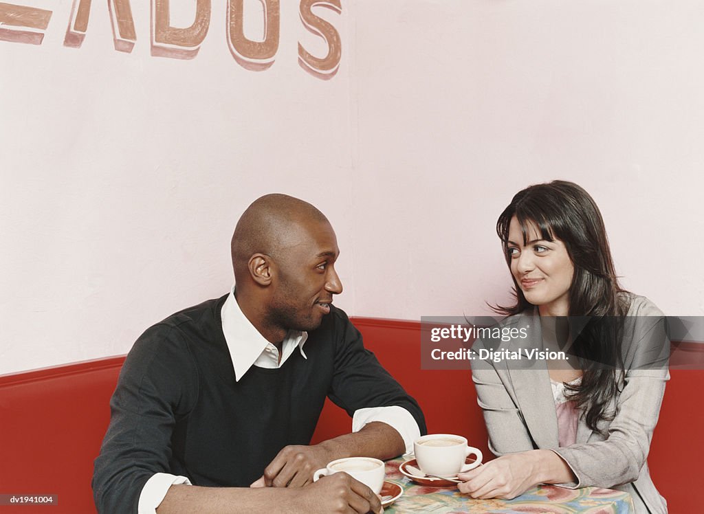 Couple Sitting at a Table in a Cafe