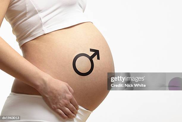 mid section of a pregnant woman with a male symbol on her stomach - male symbol ストックフォトと画像