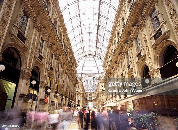 crowds in galleria vittorio emmanuelle, milan, italy - galleria stock pictures, royalty-free photos & images