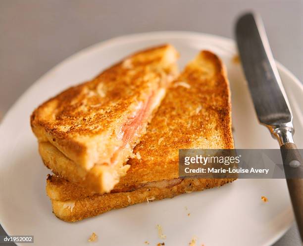 toasted ham and cheese sandwich on a plate - avery stock pictures, royalty-free photos & images