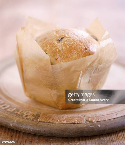 freshly baked loaf of olive bread wrapped in greaseproof paper - avery stock pictures, royalty-free photos & images
