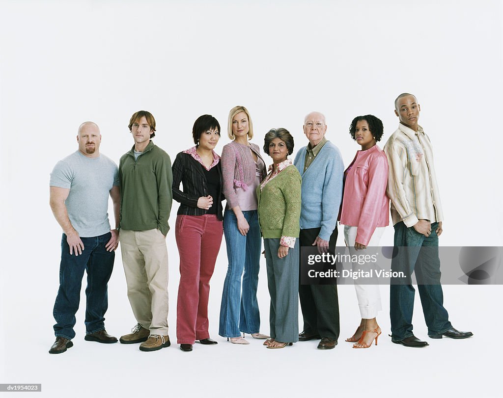 Studio Shot of a Mixed Age, Multiethnic Group of Serious Men and Women Standing in a Line