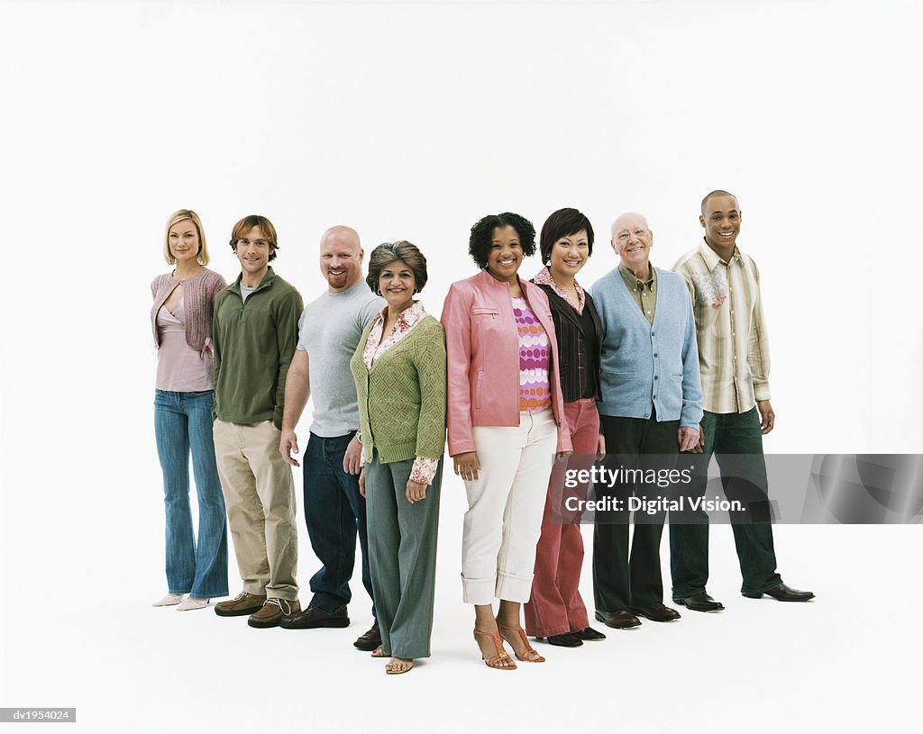 Studio Shot of a Mixed Age, Multiethnic Group of Men and Women Standing in a V Shape