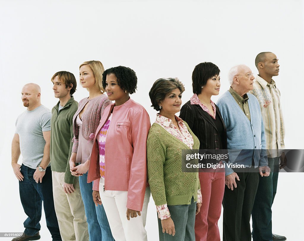 Studio Shot of a Mixed Age, Multiethnic Group of Men and Women Standing in a V Shape