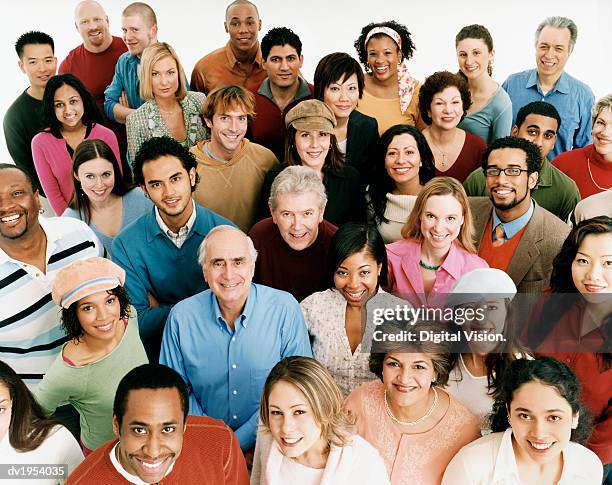 studio shot of a large mixed age, multiethnic group of smiling men and women - woman looking down smiling stock pictures, royalty-free photos & images