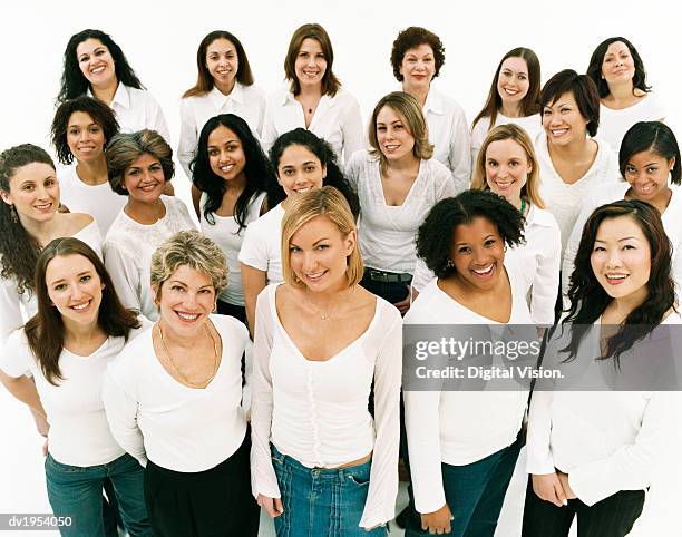 studio portrait of a mixed age, multiethnic, large group of happy women wearing white tops - solo donne foto e immagini stock