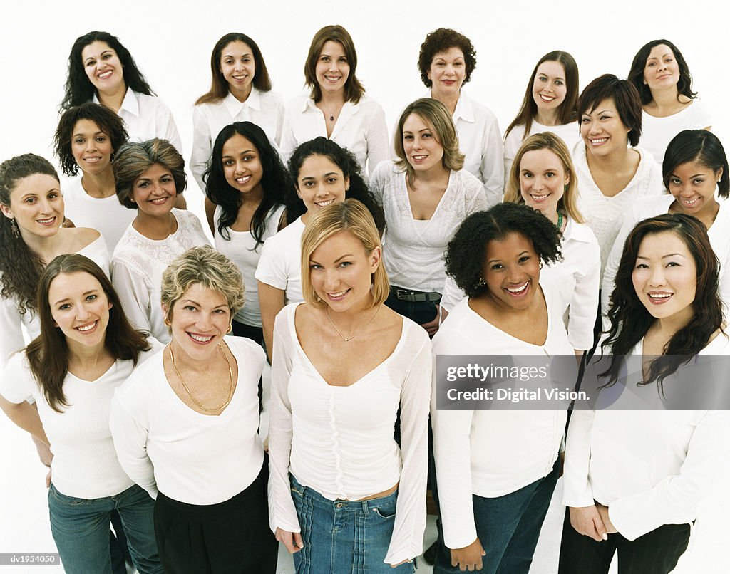 Studio Portrait of a Mixed Age, Multiethnic, Large Group of Happy Women Wearing White Tops