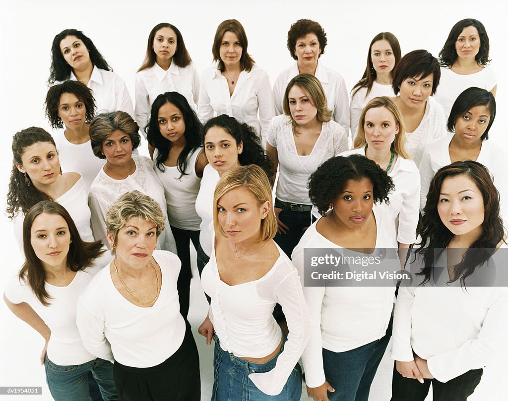 Studio Portrait of a Mixed Age, Multiethnic, Large Group of Displeased Women Wearing White Tops