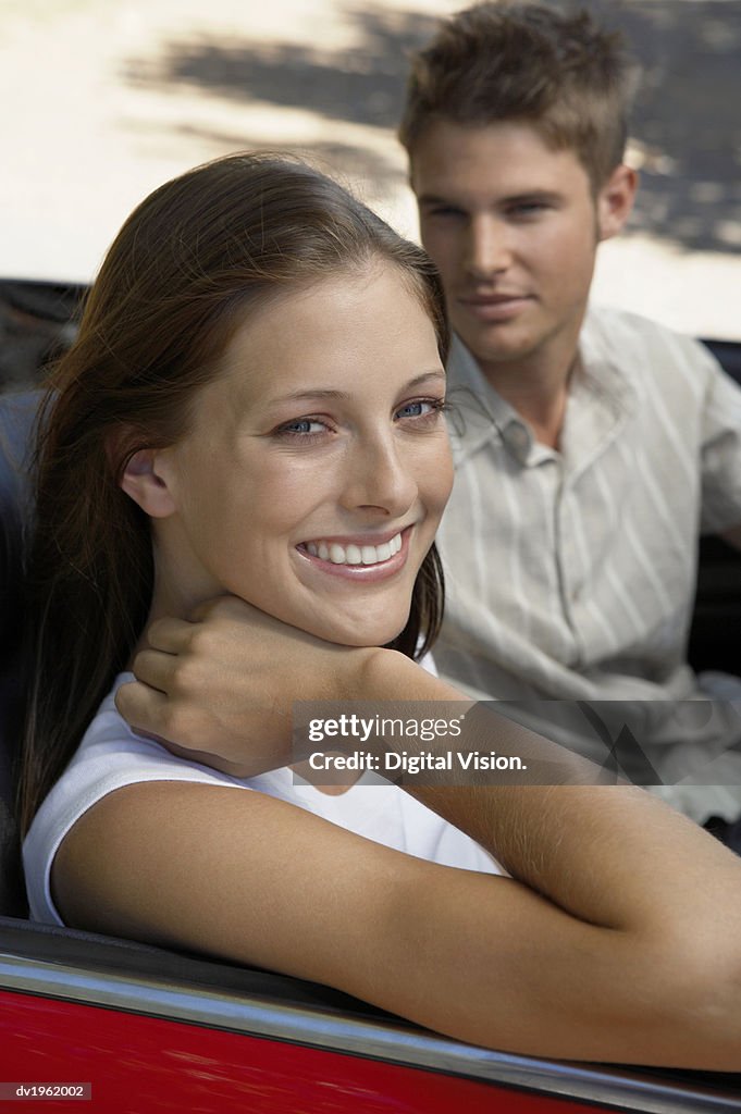 Portrait of a Couple Sitting in the Front Seat of a Convertible