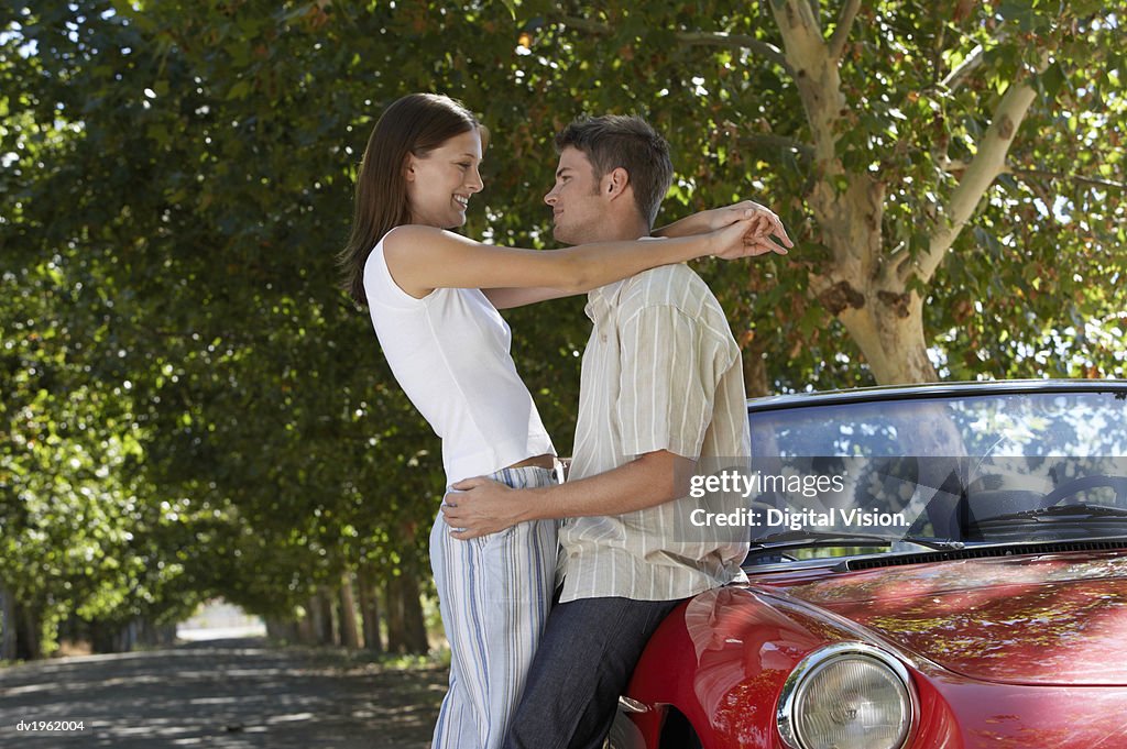 Couple Stand by a Convertible Car, Embracing