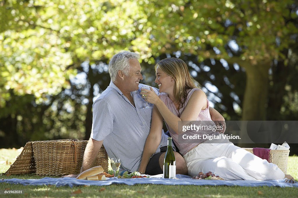 Couple Having a Picnic in a Park