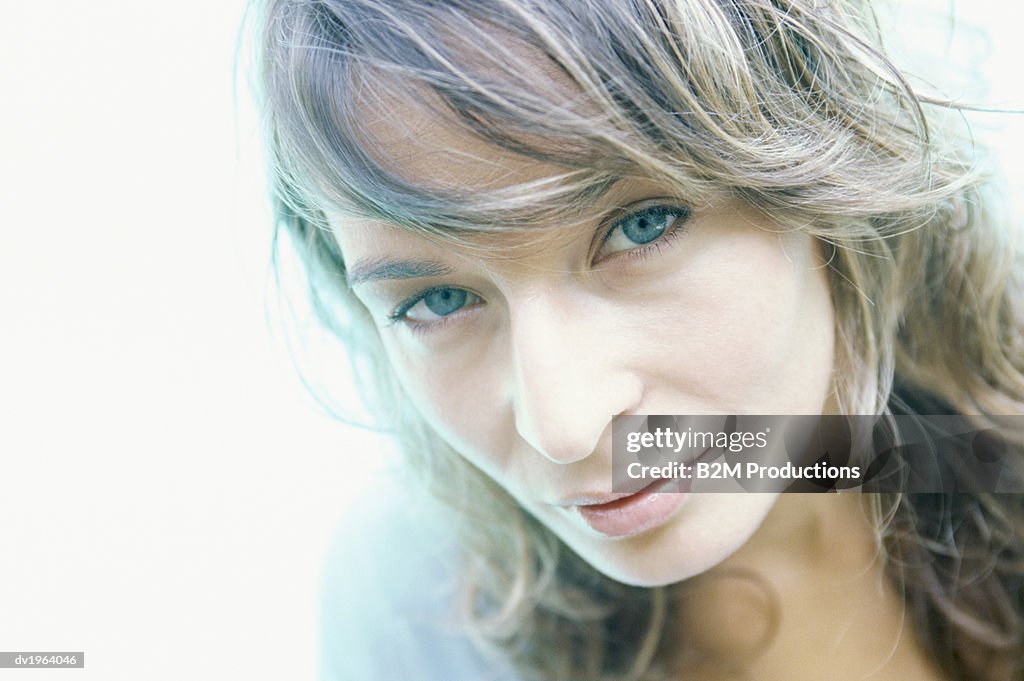 Portrait of a Woman With Long Blond Curly Hair