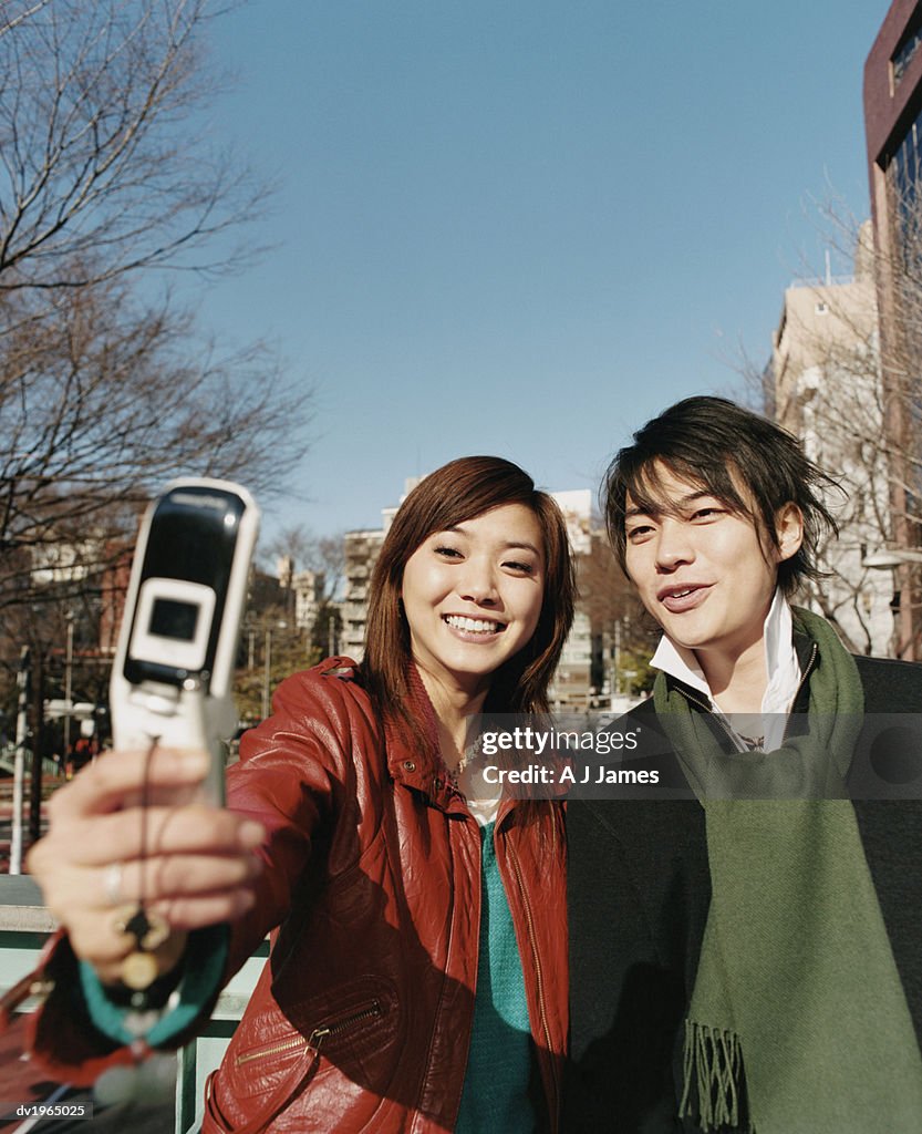 Couple Photographing Themselves with a Video Phone