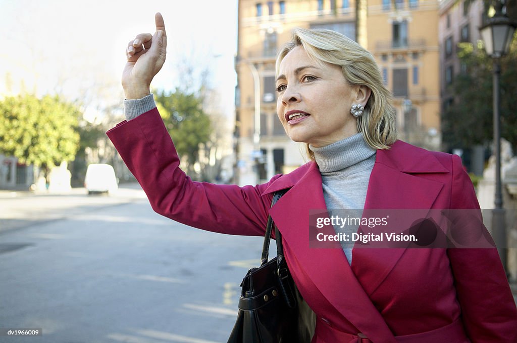 Businesswoman Standing Outdoors Hailing